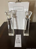 Two clear glass candlestick holders positioned side-by-side with original Bowring box behind them.