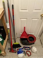 Photo showing the full set of cleaning supplies including broom, mop, dustpan, mop refill, and cleaning cloths.