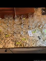 31 vintage Cornflower style glasses of various sizes on countertop, including sherbet glasses and taller glasses.