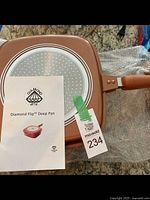 Top view of the pan's base showing the metal plate with circular patterns and Diamond Flip logo.