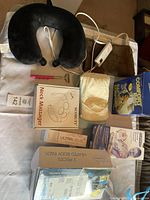 Lot arranged on white surface including a black neck pillow with control, boxed Soobody Neck Massager, two heated body pads with controllers, Ultraleve Personal Ultrasound Treatment device and gel, Comfort Bag 2 pack, and a small rectangular heating pad.