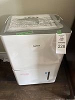 Front view of white Ivation dehumidifier with label and attached auction tag.