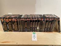 Full view of all Midsomer Murders DVD sets and single season DVDs lined up in order showing all spines.