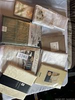 Top view of packaged tablecloths and napkins, showing various brands and styles.