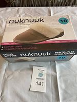 Box of Nuknuuk ladies slippers size 10 showing brand, sheepskin lining, and color information.