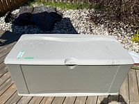 Full front view of closed deck box on wooden deck