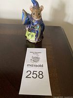Front view of the Mouse Wizard figurine with auction lot card displaying number.