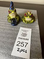 Front view of both figurines with Wizard Frog holding crystal ball and Frog Prince side by side
