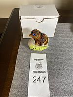 Front view showing the dragon emerging from the cracked egg with original box behind, yellow tape notes dimensions 3x3