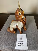 Front view of the Windstone Editions Ki Rin Unicorn Father statue on grey fabric.