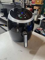 Front angled view of a black Bella air fryer showing the digital control panel and handle on the pull-out drawer.