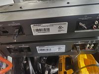 Photo shows back panels of two Bose Acoustic Wave multi-disc changers highlighting cut cords and connection ports