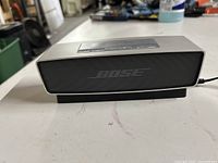 Front view of Bose SoundLink Mini speaker showing aluminum casing and black speaker grille.