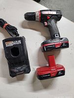 Top view of cordless drill with one battery attached and one battery shown separately, both labeled 19.2V Lithium-Ion DieHard.
