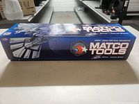 Side view of the blue Matco Tools 2009 Top Fuel Dragster die cast model box, showing branding, artwork and logos.