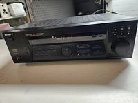 Front view of Sony FM Stereo AM/FM receiver showing control buttons, LED display, tuning dial and power indication.