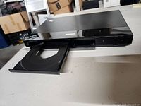 Sony Ultra HD Blu-ray player showing the open disc tray and top surface.