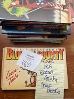 Stack of vintage Bloom County hardcover comic books by Berke Breathed, top book titled 'Loose Tails'.