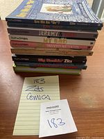 Stack of 10 ZITS comic books on a wooden surface, spines visible showing titles and authors Jerry Scott & Jim Borgman.