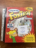 Front cover of the FoxTrot book showing the title, Bill Amend as author, and cartoon character on a red background with comic panels.