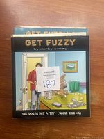 Photo of Get Fuzzy comic book cover showing man with cat and dog in bathroom.