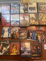 Top down photo showing 15 DVD cases arranged closely featuring movies like Bloodline, Ronin, Perry Mason, The Driver, Munich, and others.