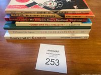 Stack of seven Canadian-themed vintage books with titles visible on the spine