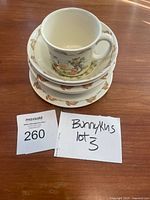 Stack of three plates, three bowls, and one cup showing the full set from above