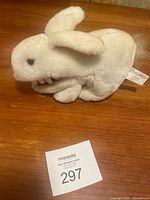 Side view of the vintage Monty Python rabbit plush showing white plush material, black eyes, and sharp teeth detail.