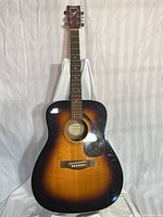 Front view of Yamaha F370TBS acoustic guitar showing sunburst finish and headstock with tuners