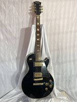 Full front view of guitar showing body shape, finish and hardware