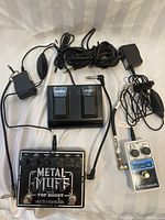 Group shot showing distortion pedal, looper pedal, footswitch and cables on white background