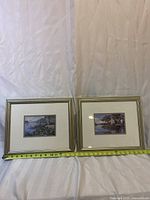 Two framed prints side by side measured approximately 11 x 14 inches each with tape measure for scale.