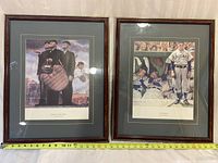 Two framed sports themed prints by Norman Rockwell shown side by side on fabric background with measuring tape indicating frame size.