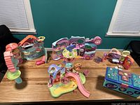 Overview of four playsets and carrying case on table