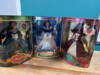 Front view of three boxed Disney Special Edition Holiday Princess Dolls: Jasmine (Aladdin), Snow White, and Belle (Beauty and the Beast).
