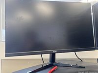 Front view of Acer monitor showing the screen and V-shaped stand with Acer logo visible on the bottom bezel.