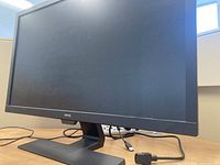 BenQ 27-inch monitor on desk with power cable visible