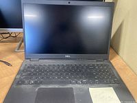 Front view of open laptop showing screen, keyboard and trackpad