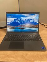 Front view of open laptop powered on showing display and keyboard