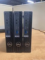 Front view of three Dell OptiPlex 7080 Micro units showing power buttons, audio jacks, USB Type-A and Type-C ports