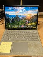 Front view open showing screen displaying Windows 10 and keyboard