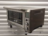 Front angled view showing overall appliance, door, controls and power cord