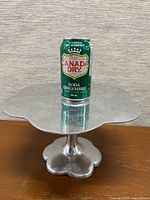 Front view showing entire cake stand with soda can for scale