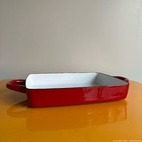 Side profile showing red exterior, white interior, and handle