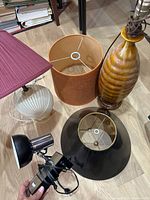 Group view of two lamp bodies, three shades, chrome desk lamp