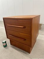 Front angled view showing overall nightstand and scale with soda can