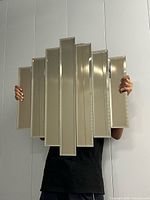 Full view of the paneled mirror held upright showing overall design and size