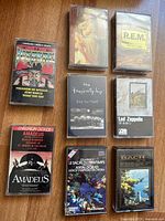 All eight cassette tapes laid out showing front covers