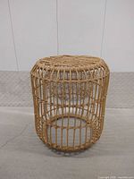 Full side view of cylindrical faux rattan stool